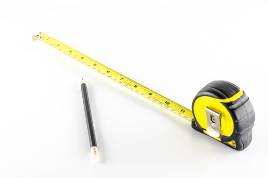 measuring tape with pencil on a white background