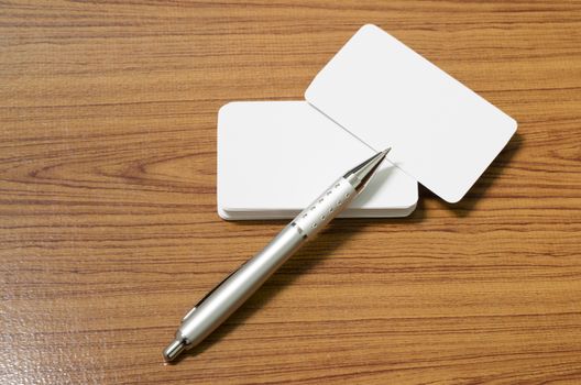 stack of business card with pen on wood background