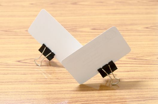 card and clip design on wood background