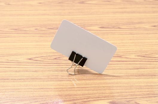 card and clip design on wood background