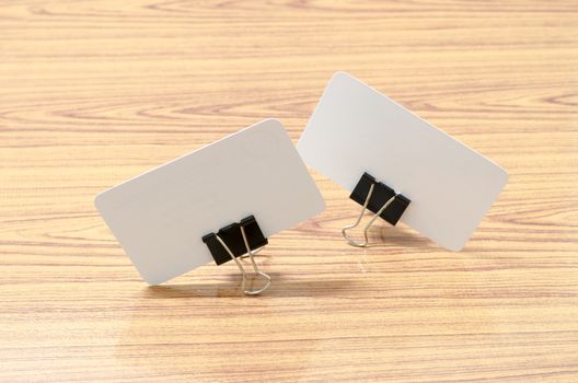 card and clip design on wood background