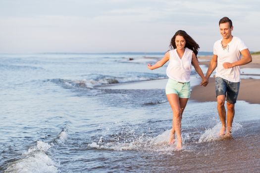 Summer, sea. Cute, lovely couple on the beach