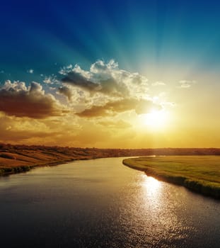 bright sunset over river with reflections