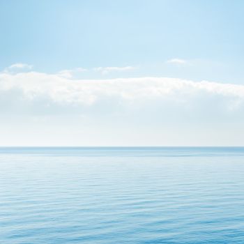 light cloud over blue sea