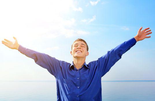 Happy Teenager with Hands Up on the Sea background