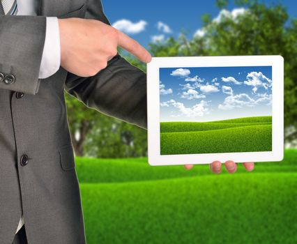 Two hands holding tablet pc on blured nature landscape background