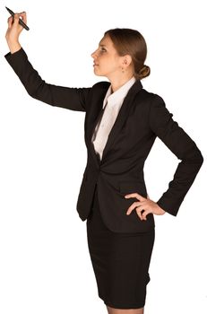 Beautiful girl in business suit holding pen and writing. Isolated on white background