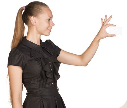 Young beautiful woman holding small imaginary object with two fingers. Isolated on white