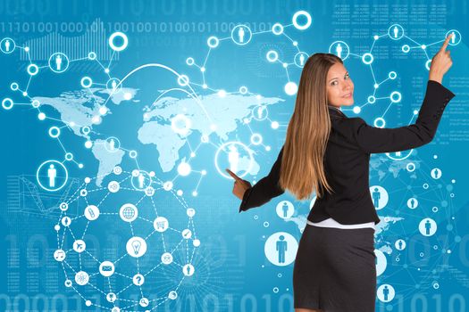 Beautiful businesswoman in suit presses fingers virtual network contacts. World map with graphs as backdrop