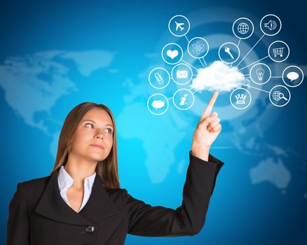 Beautiful businesswoman in suit finger presses cloud with icons. World map as backdrop