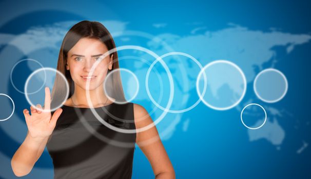 Beautiful businesswoman in dress finger presses virtual button. World map as backdrop