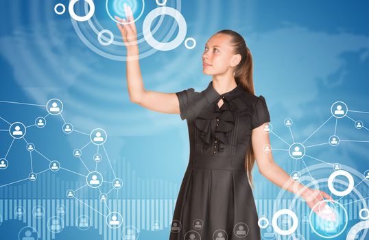 Beautiful businesswoman in dress finger presses virtual button. Graphs as backdrop