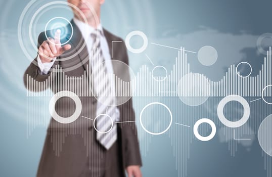 Businessman in suit finger presses virtual button. Graphs as backdrop