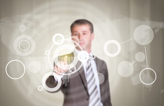 Businessman in suit finger presses virtual button. Graphs as backdrop