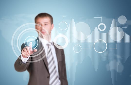 Businessman in suit finger presses virtual button. Graphs as backdrop