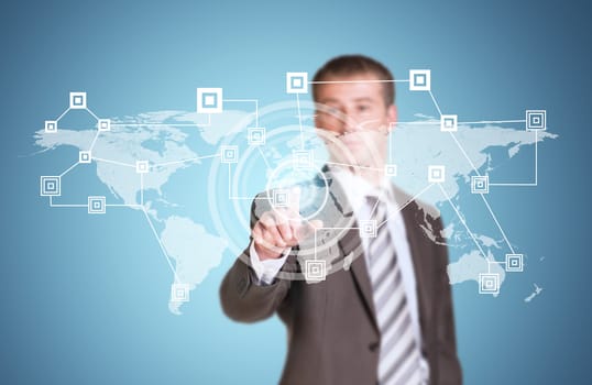 Businessman in suit finger presses virtual button. Network, circles and world map as backdrop