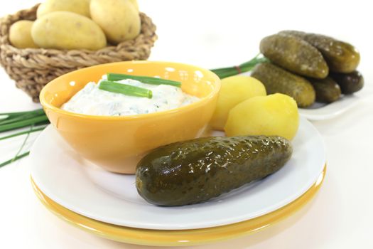 Herb curd with boiled potatoes and pickled cucumber