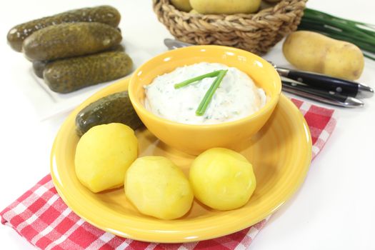 Herb curd with boiled potatoes and pickled cucumber