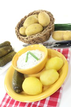 Herb curd with boiled potatoes and pickled cucumber