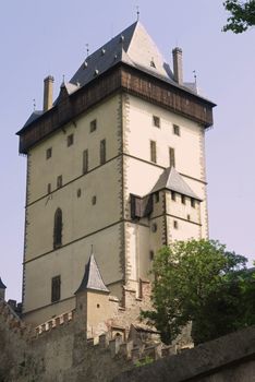 Karlstejn Castle - gateway and watch tower. Karlstejn Castle - is a famous Gothic castle founded 1348 by Charles IV - King of Bohemia. The castle served as a place for safekeeping the Imperial Regalia as well as the Bohemian coronation jewels, holy relics and other royal treasures. Located about 30 km southwest of Prague above the village named Karlstejn, it is one of the most famous and most frequently visited castles in the Czech Republic. The castle was founded in 1348 by Charles IV.