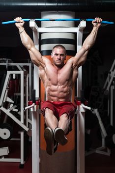 Handsome Man Exercising His Abs At The Gym