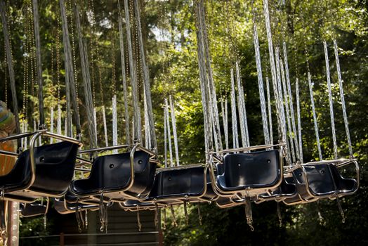 Empty swing seats at a fun fair