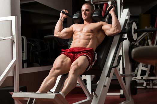 Male Bodybuilder Doing Heavy Weight Exercise For Legs