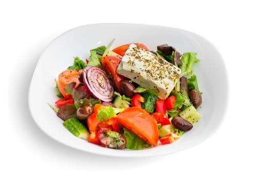 closeup of greek salad with large piece of feta