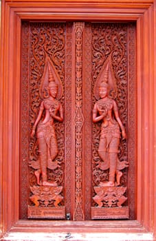 Antique carved wooden door in temple Thailand