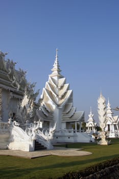 Modern Buddhist sculpture,.
White temple in Thailand.