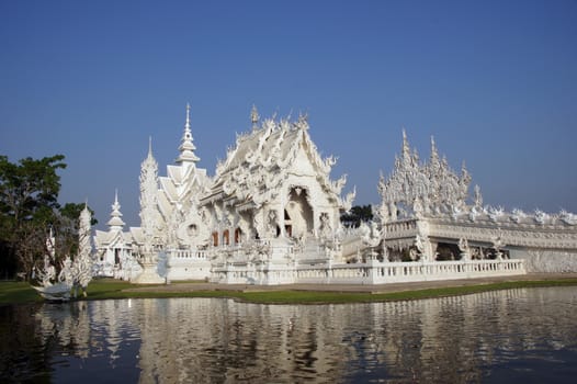 Modern Buddhist sculpture,.
White temple in Thailand.