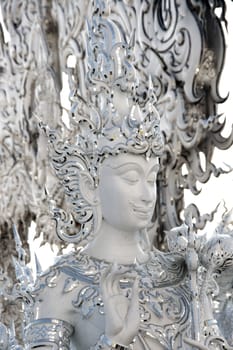 Modern Buddhist sculpture,.
White temple in Thailand.