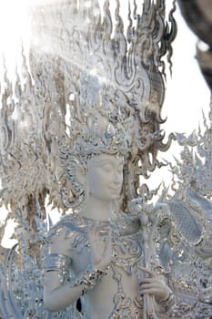 Modern Buddhist sculpture,.
White temple in Thailand.