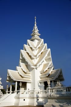 Modern Buddhist sculpture,.
White temple in Thailand.