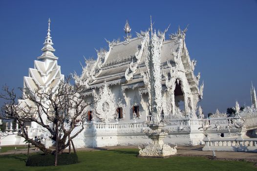 Modern Buddhist sculpture,.
White temple in Thailand.