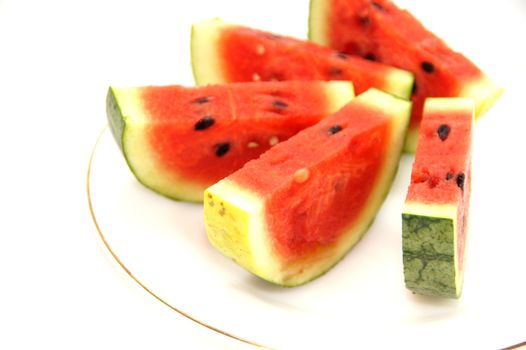 Sliced watermelon on plate isolated on a white background.