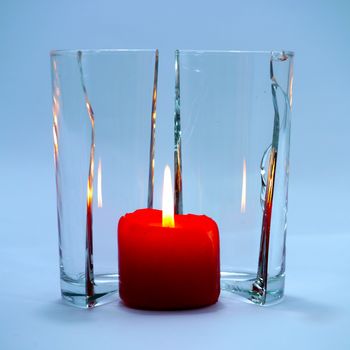 Red candles in glass cracking.