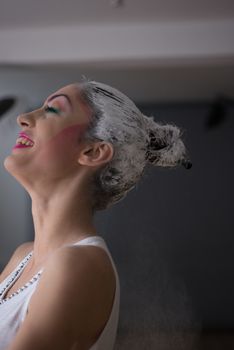 Smiling model during make up placement