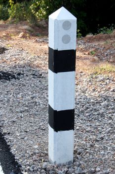 Stone pillars prevent accidents on the road curved.