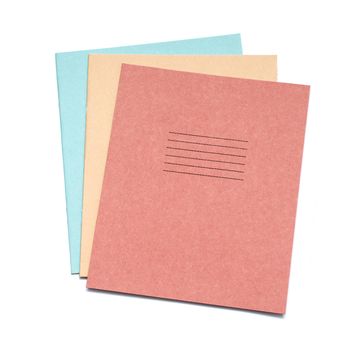 multicolored exercise books over the white background