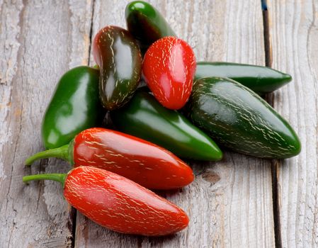 Heap of Red and Green Habanero and Jalapeño Chili Peppers isolated on Rustic Wooden background