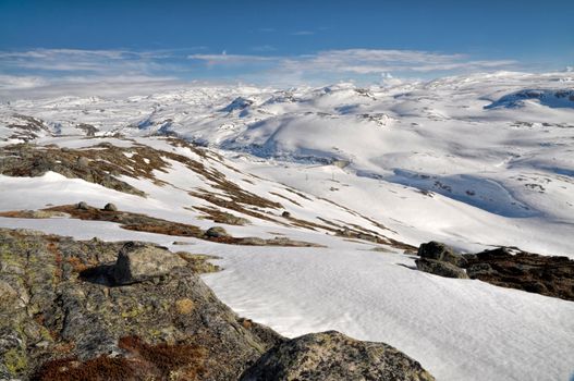 Panoramic view of snow-covered hills in the mountains near Trolltunga, Norway