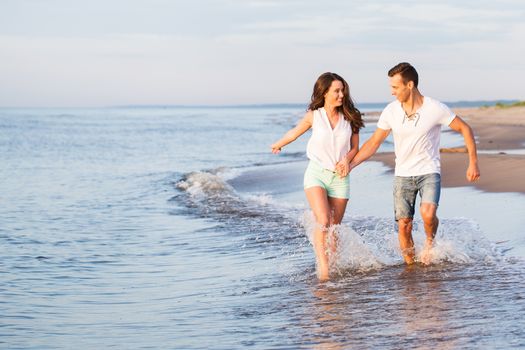 Summer, sea. Cute, lovely couple on the beach