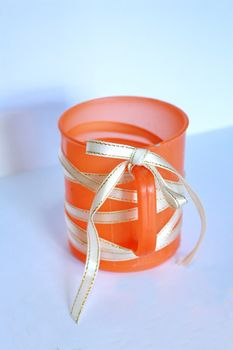 The orange mug cover by ribbon.Make it worth to using.