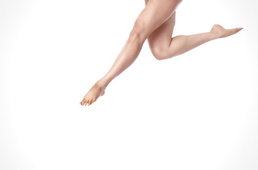 Legs of jumping woman. Horizontal photo