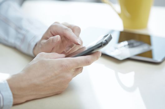 Hands of smartphone user at lunch