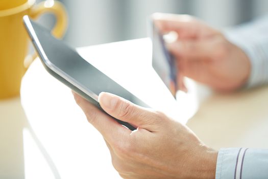 Hands of woman with credit card and digital PC