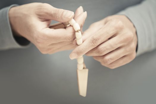 Hands with rosary beads. Close-up view