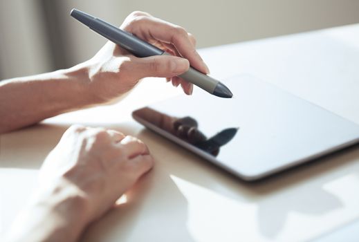 Hands of woman working with digital tablet