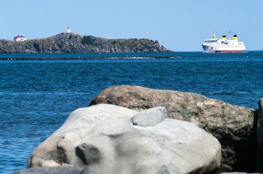Ferry entering port  around the Swallow Tail Lighthouse on Grand Maman